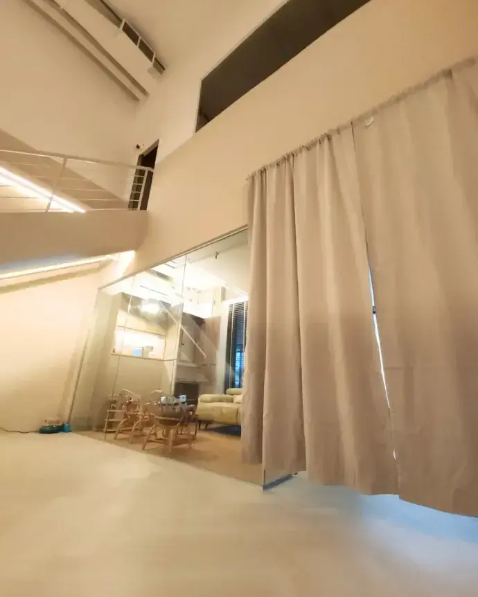 The full height curtain drawn across the mirrored wall
