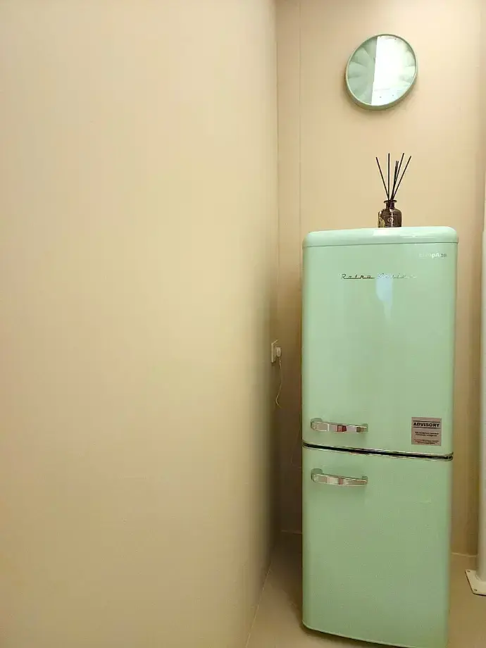 The mint green retro fridge that fits a two tier cake