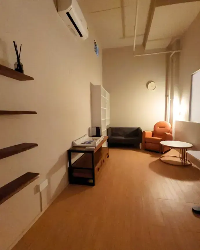 The quiet room with a sofa, a nursing chair and open shelves